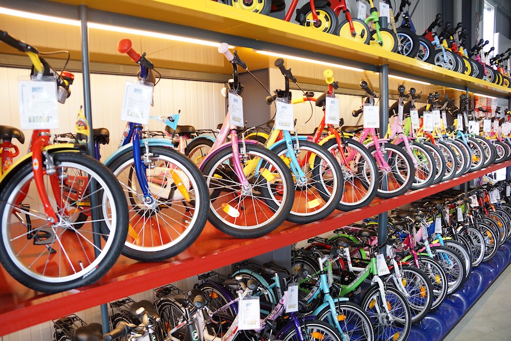 Kids Bike Test - Many different children's bicycles in the high rack in bicycle store
